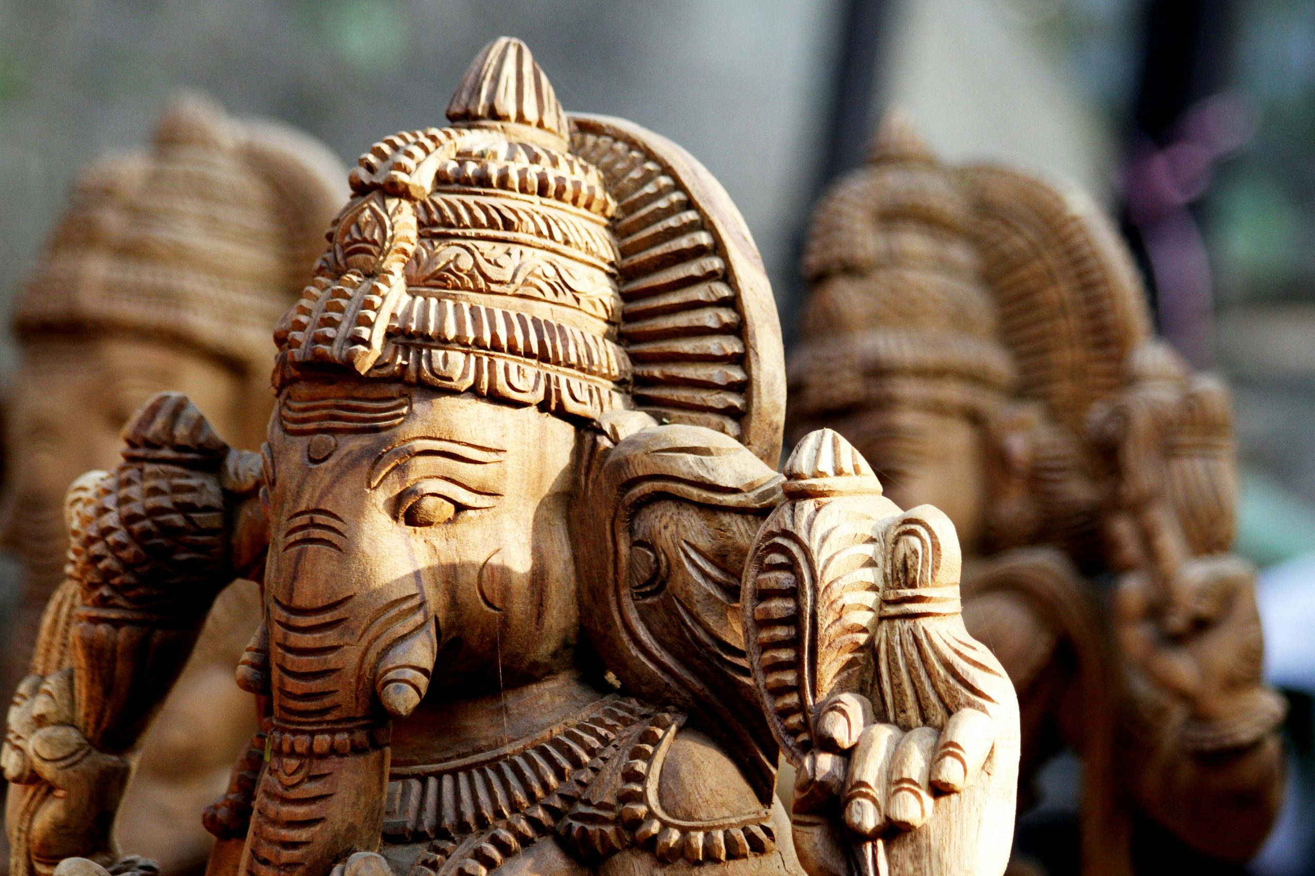 Close-up of a detailed wooden Ganesha statue showcasing intricate craftsmanship.